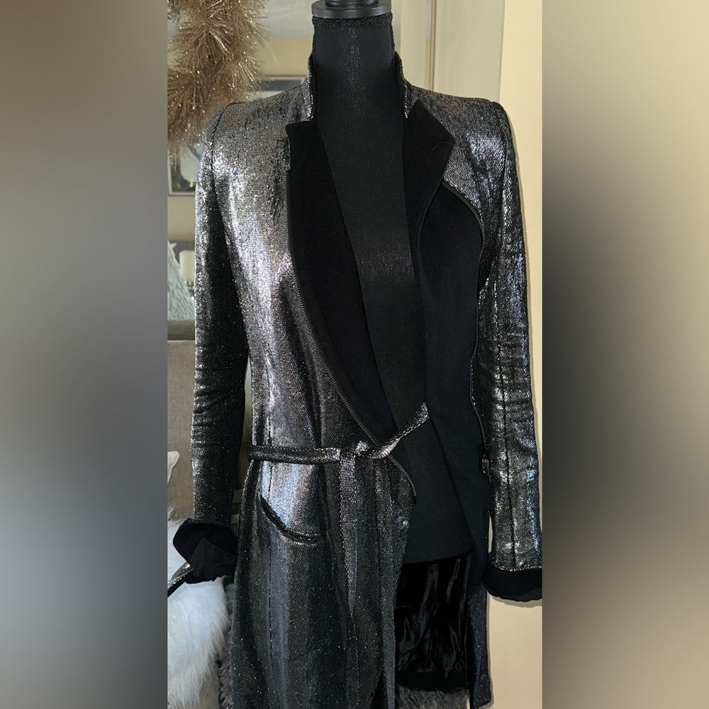 jacket has black interior lining with black French cuff silver metallic exterior